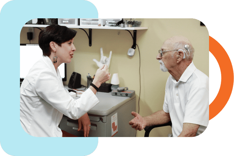 Dr. Joanie Davis test fitting a Cochlear Implant on a mature man